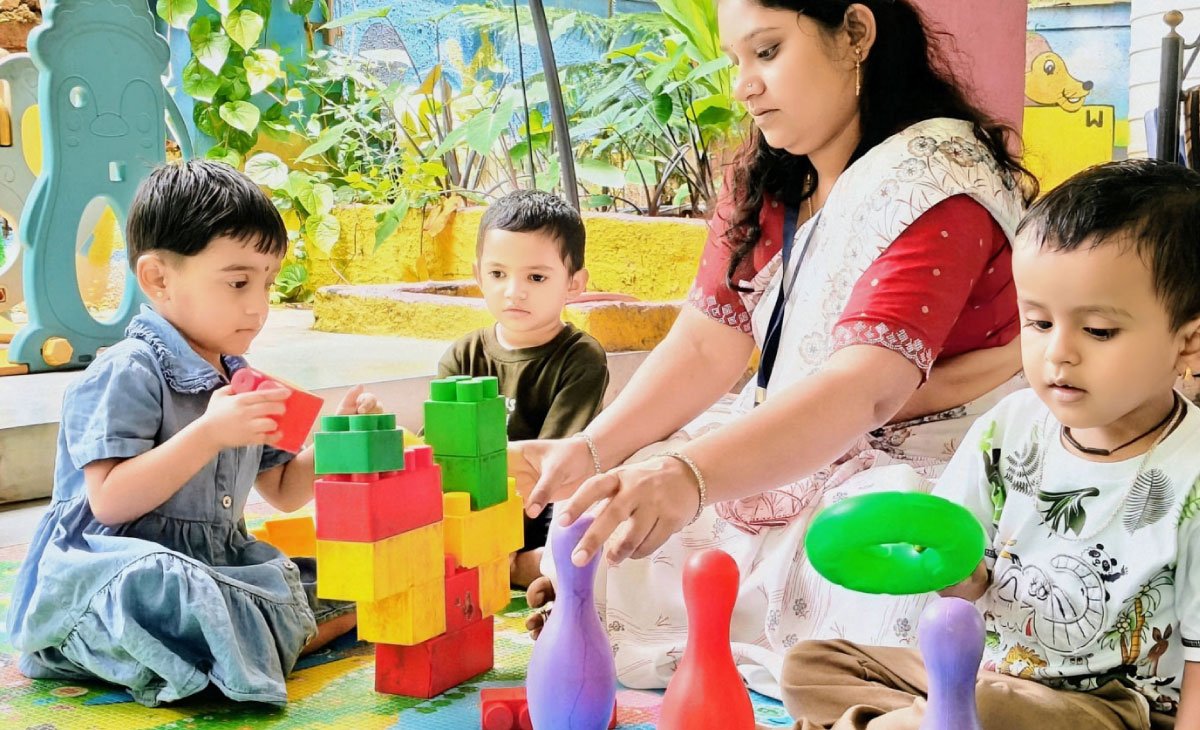 Teacher helping student with homework during tuition session at Utkarsha School